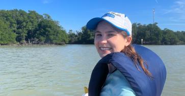 woman in kayak smiling at camera